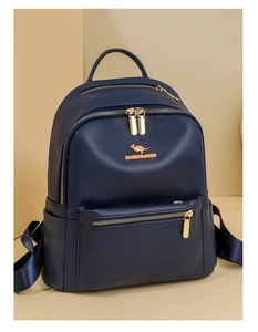 Close-up of dark blue PU leather backpack with gold kangaroo logo and metallic zippers