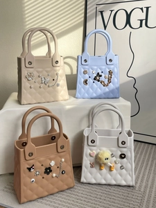 Detail of candy-colored EVA handbags with DIY charms and lattice pattern in natural light