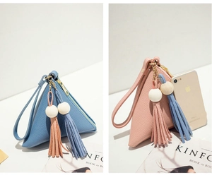 Detail of blue and pink mini triangular coin purses with tassels and wrist straps