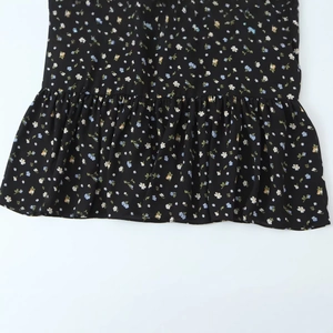 Floral print sleeveless maxi dress with a ruffled hem and a slim waist design in black