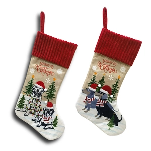 Hanging knitted Christmas stockings featuring cute pet dog prints with Merry Christmas text