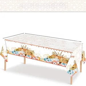 Detailed view of disposable Thanksgiving tablecloth with pumpkin and maple leaf patterns