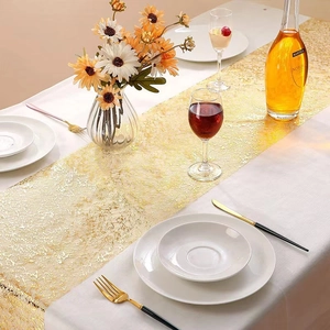 Golden lace mesh table runner on white cloth for wedding and home dining decoration