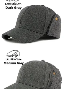 Detailed view of warm wool baseball caps with thick fleece earflaps in grey tones