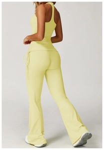 Detail view of yellow yoga flare pants featuring side drawstrings and high waist cut