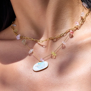 Detail of 18K gold stainless steel layered necklace with colorful stones and oval pendant