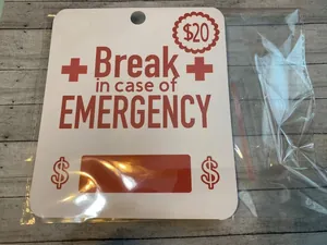 Creative emergency $20 money holder card with break glass design on wooden table