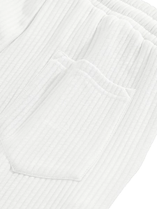 Detail view of white corduroy men's shorts featuring rear pocket and elastic waistband