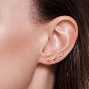 Golden ear climber with colorful cubic zirconia crystals on female model ear