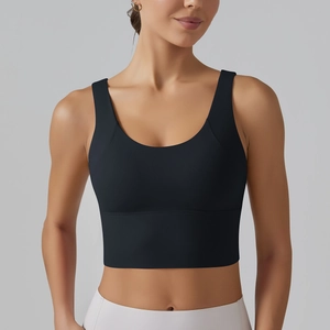 Detailed view of the wide elastic hem and deep U-neckline on the black sports bra