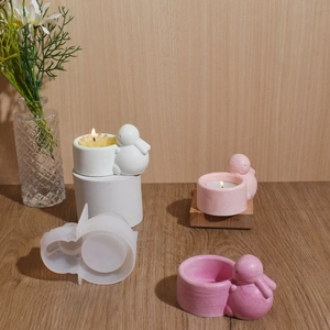 Macro view of bunny candle holder resin mold with finished plaster birds and tea light candle