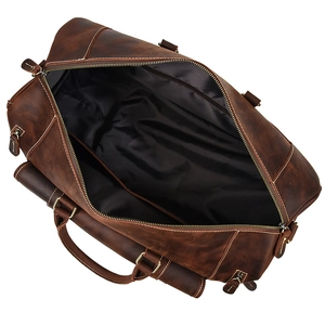 Top view of open crazy horse leather travel bag showing spacious black lining and sturdy zip
