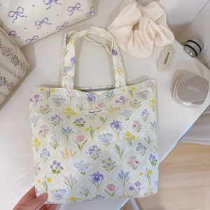 Detail of floral canvas tote bag with small flower patterns and simple wish label