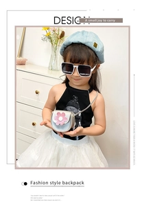 Detailed view of child's silver glitter flower crossbody bag worn by a young girl