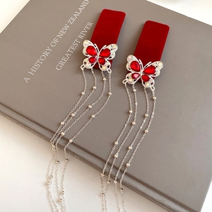 Detail of red flocked butterfly hair clips with sparkling rhinestones and long tassels