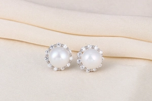 Macro shot of S925 silver pearl stud earring with sparkling cubic zirconia halo inlay