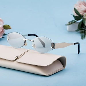 Fashion rimless hexagonal sunglasses with silver metal frame on a beige leather case