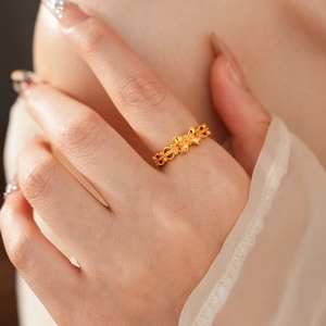 Detail of vintage golden flower ring with zircon on finger and elegant lace cuff