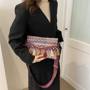 Detail of colorful zigzag woven pattern and boho tassels on ethnic crossbody bag