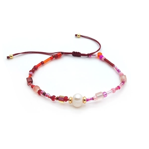 Detail of adjustable red cord bracelet with freshwater pearl and colorful glass beads