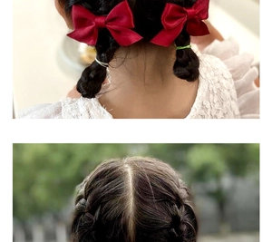 Detail of red satin bow hair clips shown on braided hair for girls hair accessories