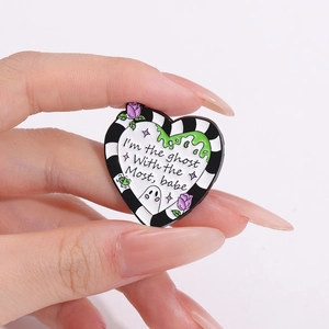 Heart-shaped enamel ghost brooch with I'm the ghost with the most babe text design