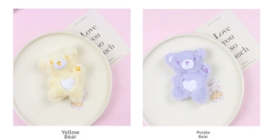 Detailed view of yellow and purple plush bears with heart embroidery and soft fur texture
