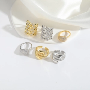 Collection of minimalist gold and silver open rings in teardrop and nail wrap designs