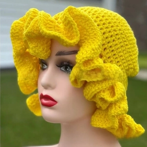 Close-up of yellow crochet knit hat with oversized ruffle brim for festive styling