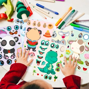 Close-up of children hands making DIY cartoon animal stickers with panda and dinosaur
