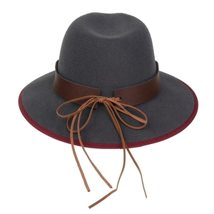 Detail of dark grey wool fedora hat featuring burgundy trim and brown leather band
