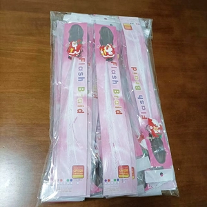 Close-up of LED fiber optic flash braid hair clip with Santa Claus ornament in packaging
