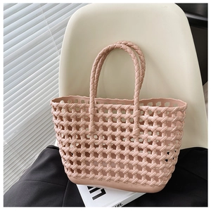 Detailed view of a pink woven jelly tote bag resting on a chair for summer vacation