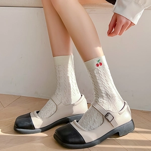 White cable knit socks with cherry embroidery paired with two-tone Mary Jane shoes