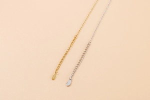 Close-up of S925 sterling silver authenticity hallmarks on gold and silver extender chains