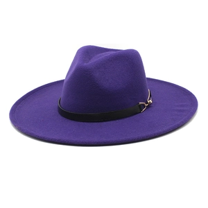 Detail of purple wool fedora hat with wide brim, black leather band and gold buckle