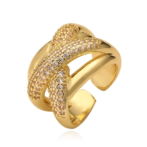 Irregular geometric criss-cross open ring in warm gold with micro-set zircon stones