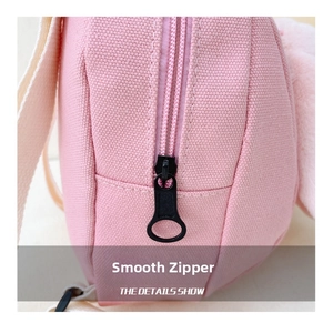 Detail of pink canvas fabric featuring a durable black metal zipper and smooth stitching