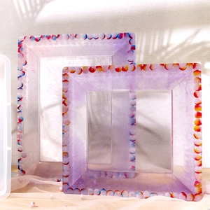 Detail of DIY epoxy resin frames with purple glitter finish and colorful polka dot borders
