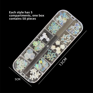 Close-up of 58-piece aurora butterfly and flower nail art charms in a 12-grid organizer box