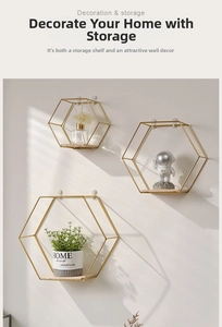Three hexagonal gold metal wall shelves with wooden trays for home decor and storage