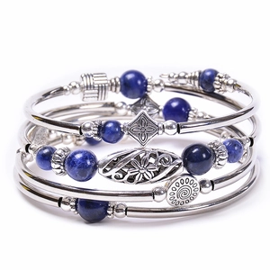 Macro shot of multi-layer bracelet with lapis blue beads and bohemian metal charms
