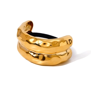 Golden chunky stainless steel hair tie with irregular liquid metal texture on white background