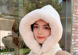 Macro detail of plush faux fur hooded scarf showing soft texture and warm white fabric