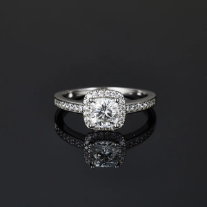 Macro detail of cushion-cut moissanite halo ring with silver plated pave setting