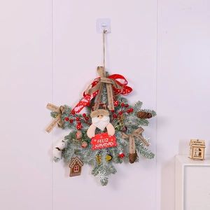 Detail of snowflake Christmas wreath with Santa doll pine cones and red berries