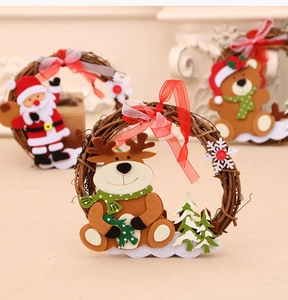 Close-up of handmade wooden rattan Christmas wreath with plush reindeer and Santa dolls