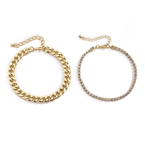 Detail of gold-plated chunky Cuban link and sparkling rhinestone tennis chain anklet set