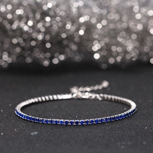 Macro shot of 2mm silver tennis bracelet with deep blue zircons and adjustable chain