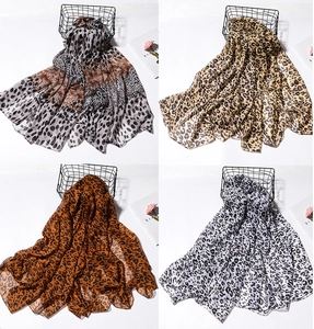 Collage of four leopard print lightweight silk scarves in various color combinations